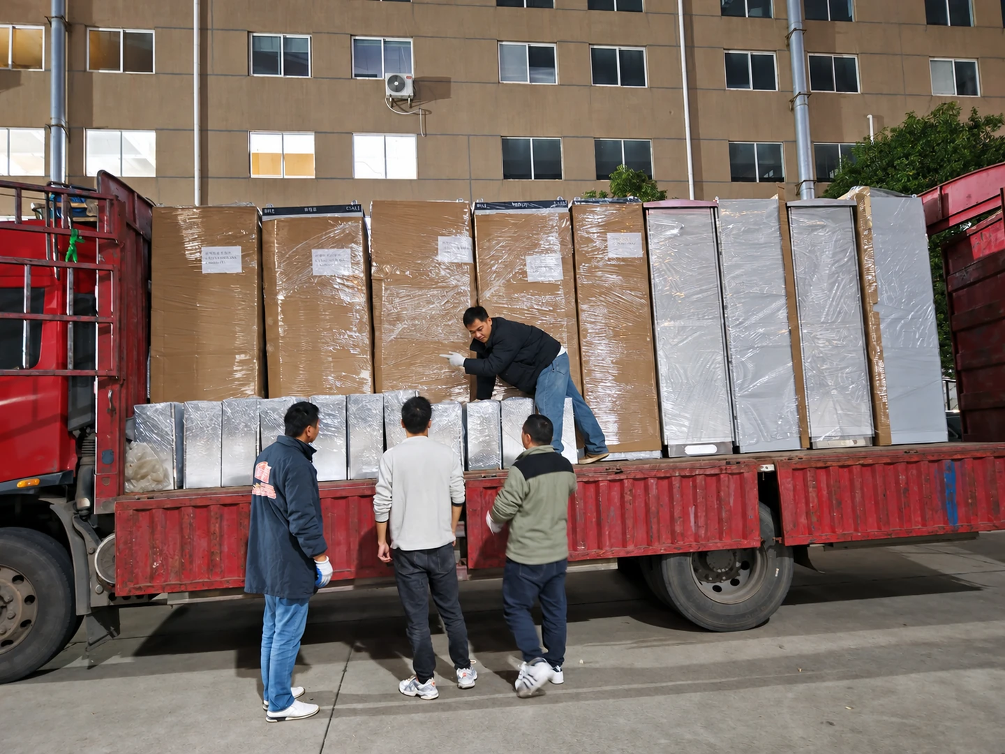 Wrapped electrical cabinets being loaded onto a truck